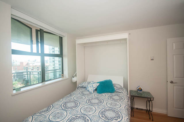 Spacious bedroom with a built-in Murphy bed, hardwood floors, and a city view. - 801-1128 Quebec st, Vancouver Downtown