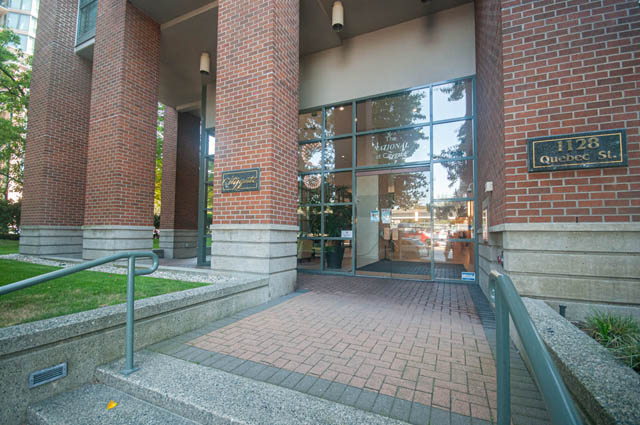 Spacious 2-bedroom condo entrance with glass doors and brick facade. - 801-1128 Quebec st, Vancouver Downtown