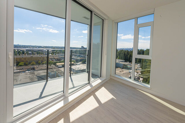 Bright living room with expansive city view and large windows. - 1105 - 1401 Hunter Street, North Vancouver