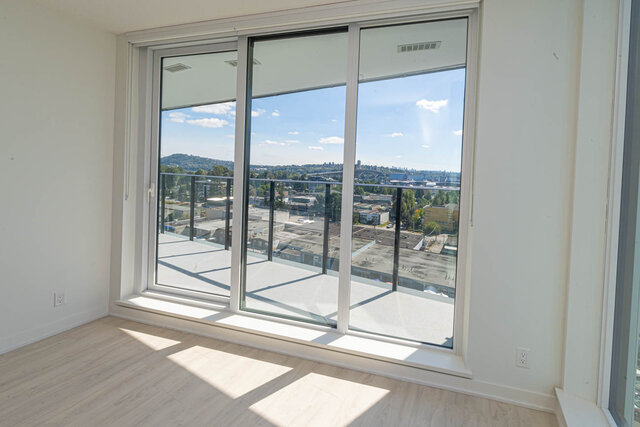 Bright living room with expansive city view and hardwood floors. - 1105 - 1401 Hunter Street, North Vancouver