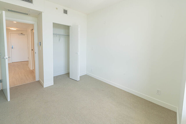 Spacious den with carpeted floor and closet, ready for furnishings. - 1105 - 1401 Hunter Street, North Vancouver