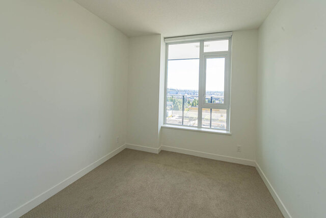 Spacious den with large window offering city views and neutral carpeting. - 1105 - 1401 Hunter Street, North Vancouver