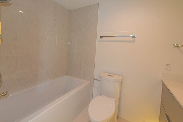 Spacious bathroom with modern fixtures and a sleek bathtub. - 1105 - 1401 Hunter Street, North Vancouver