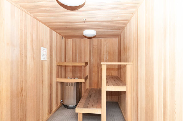 Spacious, modern sauna with wooden benches and shelves. - 1105 - 1401 Hunter Street, North Vancouver