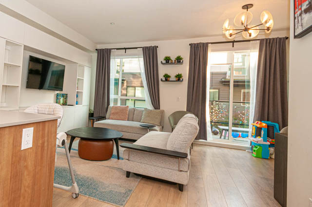 Furnished living room with hardwood floors, city view, and modern decor. - 30 - 533 East 3rd st., North Vancouver