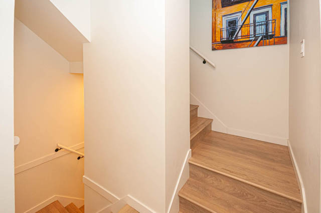 Staircase leading to upper level with modern decor and artwork. - 30 - 533 East 3rd st., North Vancouver