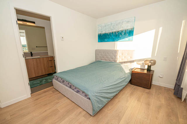 Bright bedroom with hardwood floors and a city view. - 30 - 533 East 3rd st., North Vancouver