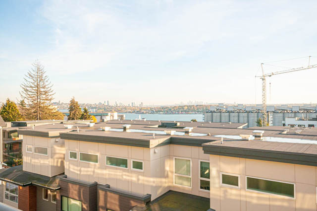 Bright living room with city view and modern furnishings. - 30 - 533 East 3rd st., North Vancouver
