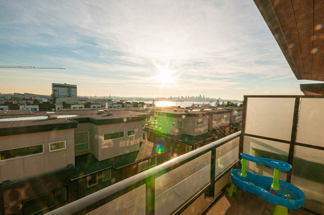 Bright living room with city view and modern furnishings. - 30 - 533 East 3rd st., North Vancouver