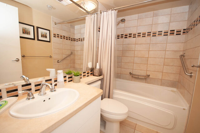 Spacious bathroom with beige countertops, tiled walls, and a walk-in shower. - 1605 - 1199 Marinaside Crescent, Vancouver Downtown