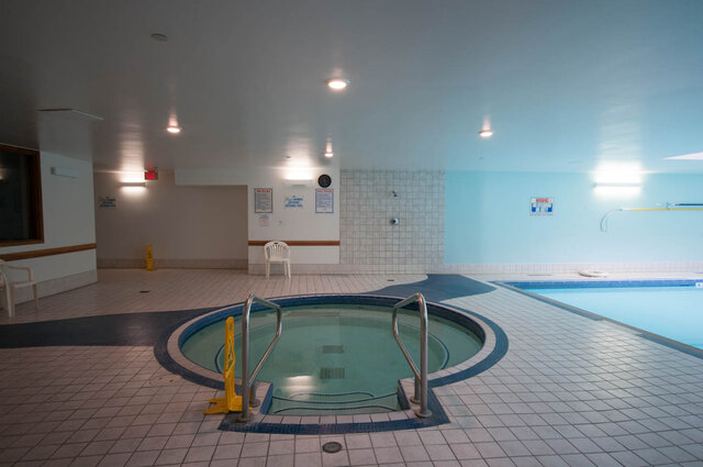 Spacious indoor pool area with tiled floors and a hot tub, perfect for relaxation. - 1605 - 1199 Marinaside Crescent, Vancouver Downtown