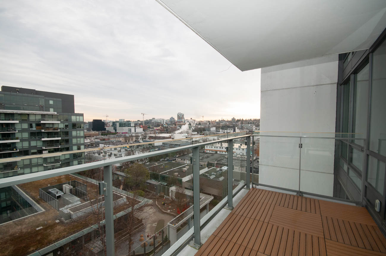 Furnished balcony with city view and wooden deck. - 1403 - 159 West 2nd, Vancouver West Side