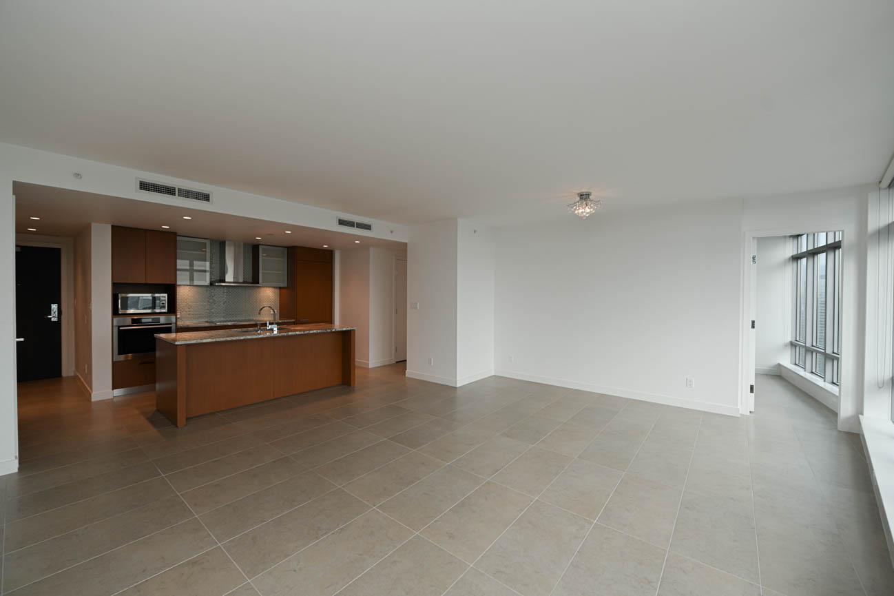 Bright open-concept living room with modern kitchen and hardwood floors. - 3501 - 1028 Barclay, Vancouver Downtown