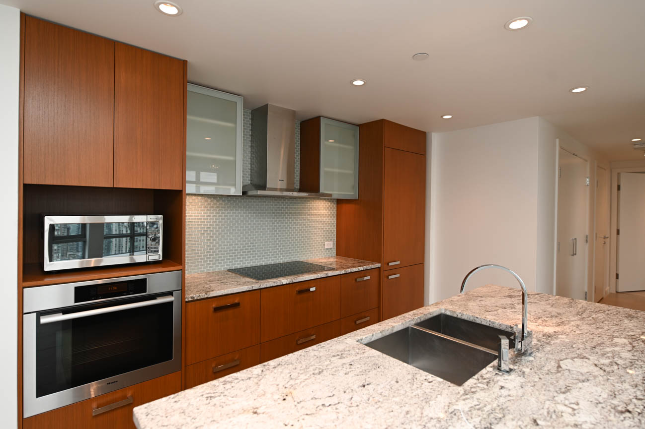 Bright kitchen with granite countertops, modern cabinetry, and a city view. - 3501 - 1028 Barclay, Vancouver Downtown