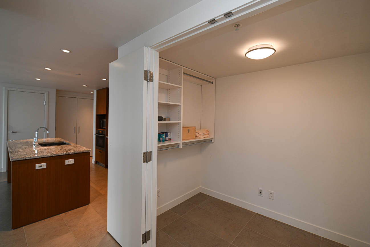 Bright kitchen with granite countertops and a sliding door leading to a storage area. - 3501 - 1028 Barclay, Vancouver Downtown