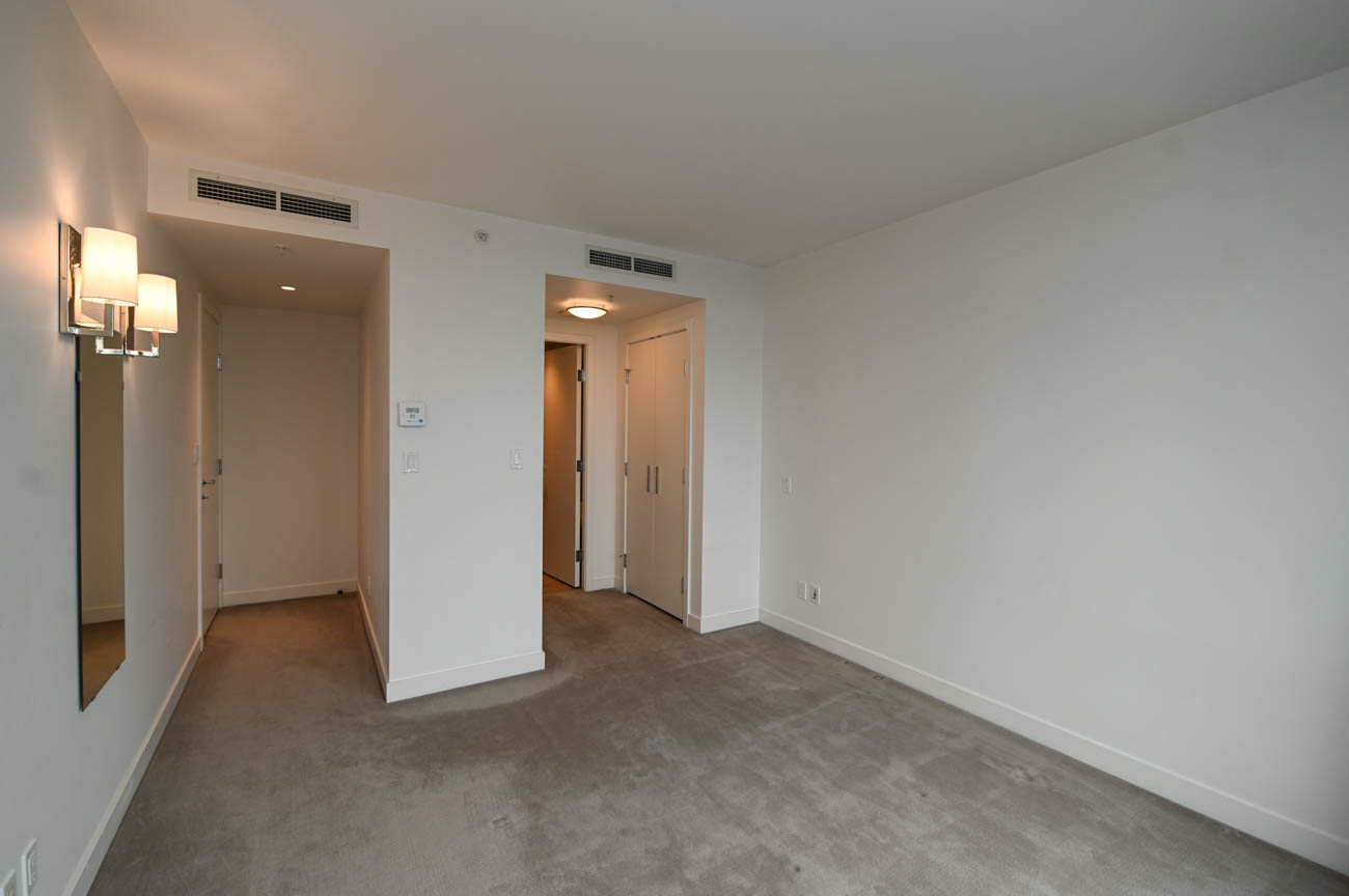 Bright hallway leading to bedrooms with neutral carpeting and modern lighting. - 3501 - 1028 Barclay, Vancouver Downtown