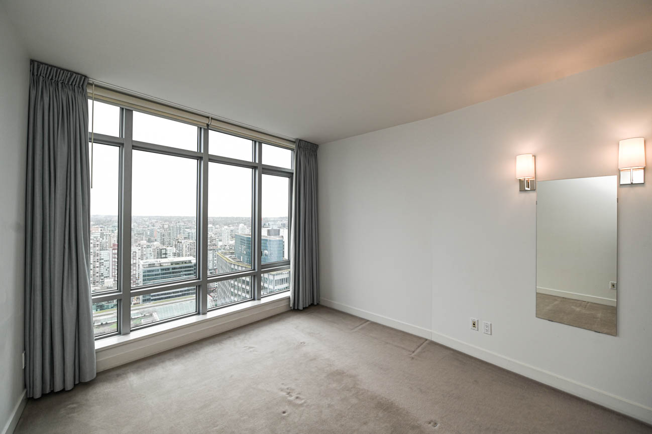 Bright living room with large windows offering a city view and modern decor. - 3501 - 1028 Barclay, Vancouver Downtown