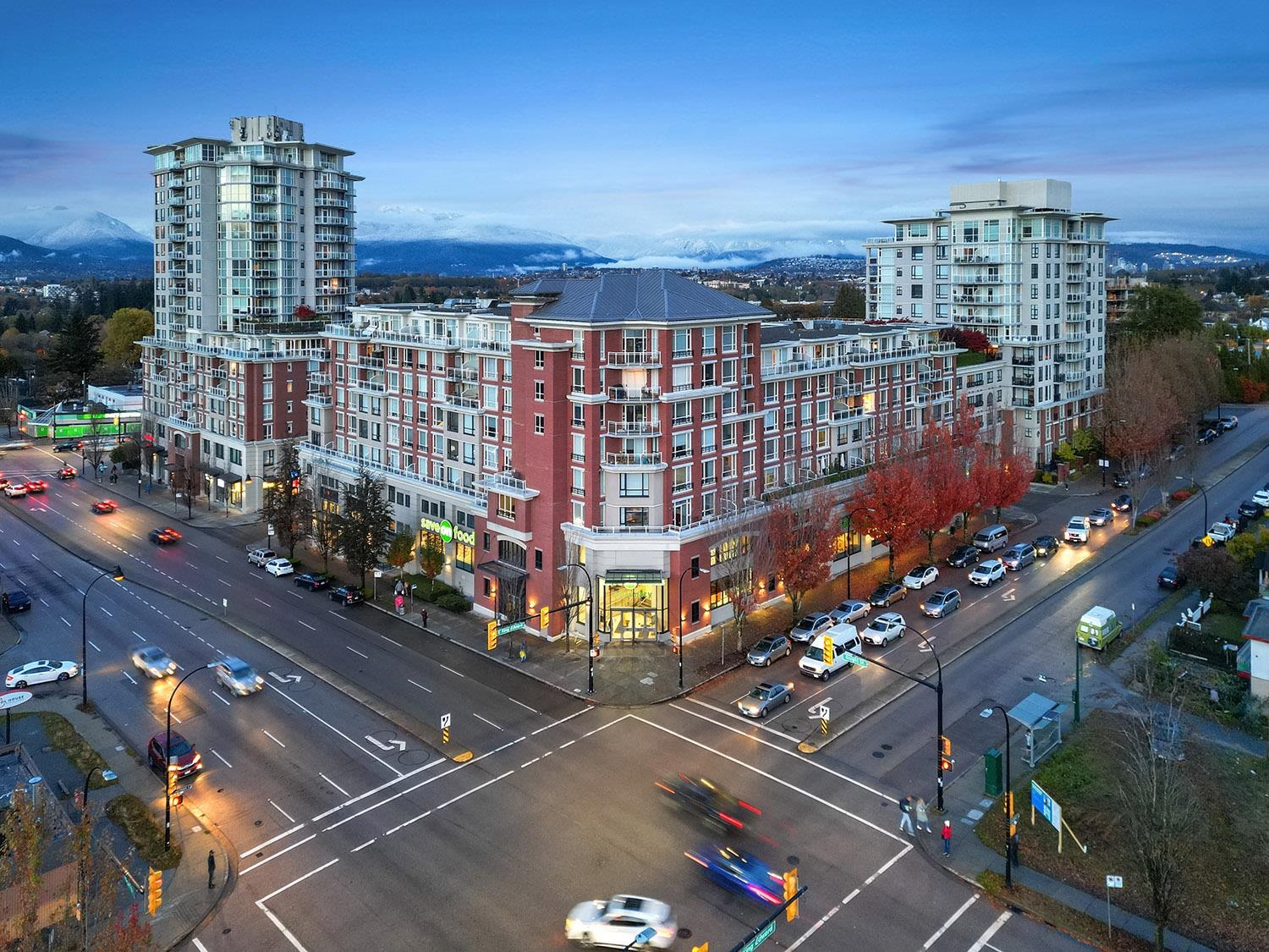 Balcony with city skyline view and red-brick building facade. - 807 - 4078 Knight Street, Vancouver East Side