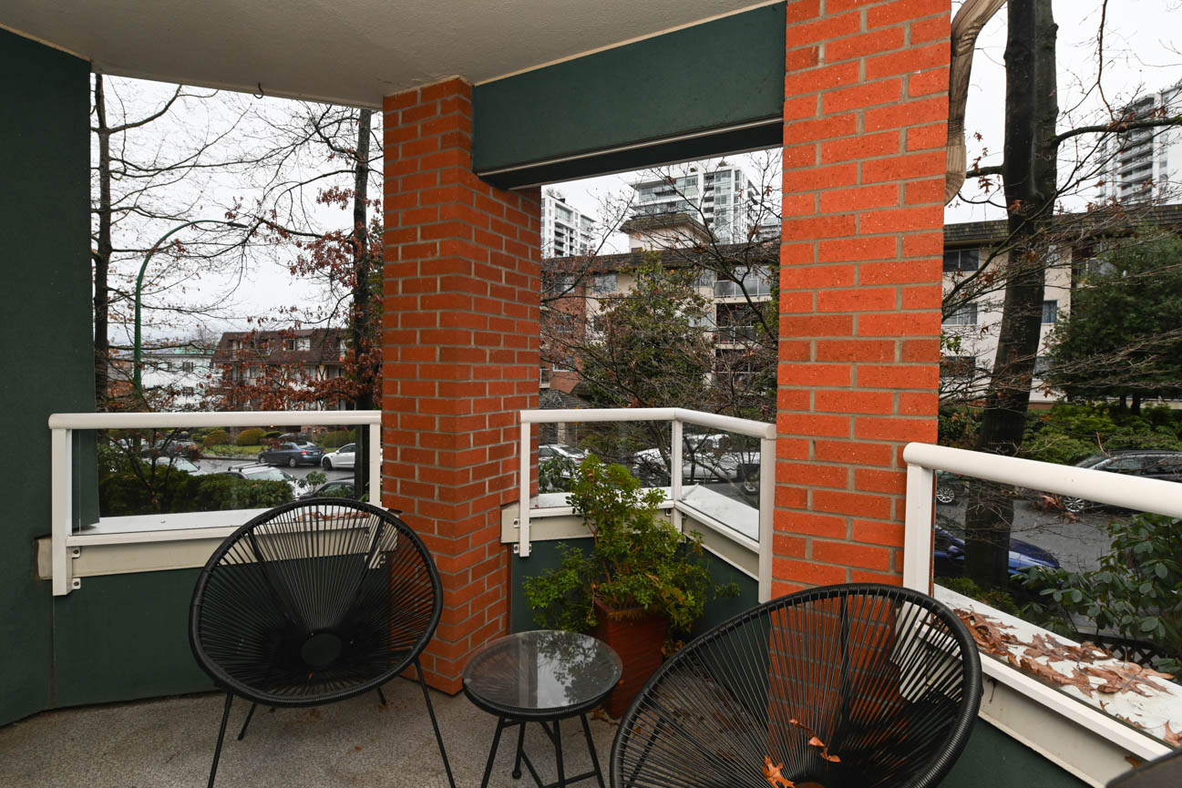Furnished balcony with brick pillars and city view. - 208-128 8th Street West, North Vancouver