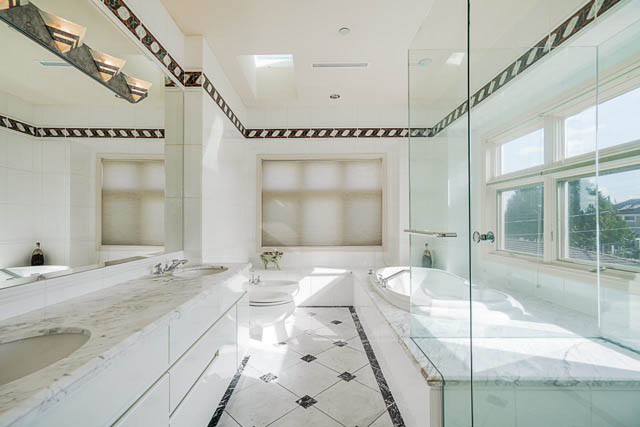 Spacious bathroom with marble countertops and large windows offering a city view. - 1128 W 49th, Vancouver West Side