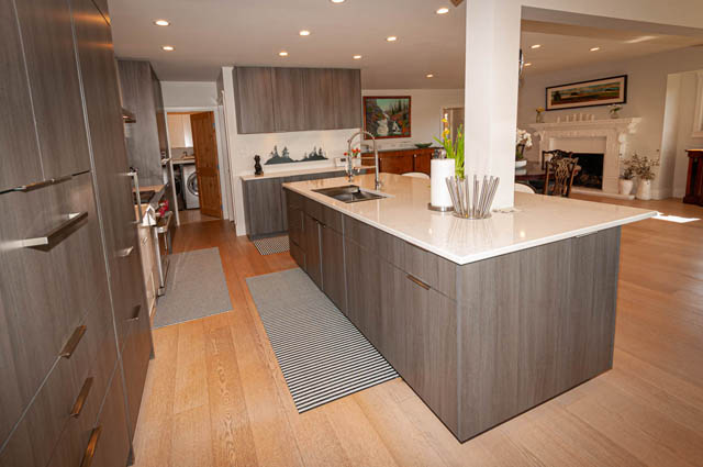 Bright kitchen with modern island, light wood cabinets, and hardwood floors. - 2128 Grand Blvd, North Vancouver