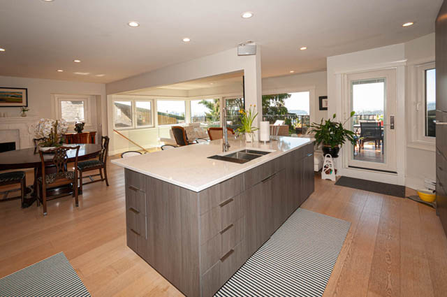 Bright kitchen with modern island, hardwood floors, and city view. - 2128 Grand Blvd, North Vancouver
