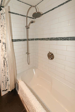 Bathroom with white subway tiles, modern shower setup, and a bathtub. - 2128 Grand Blvd, North Vancouver