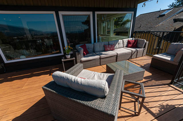 Spacious deck with wicker furniture and city view. - 2128 Grand Blvd, North Vancouver