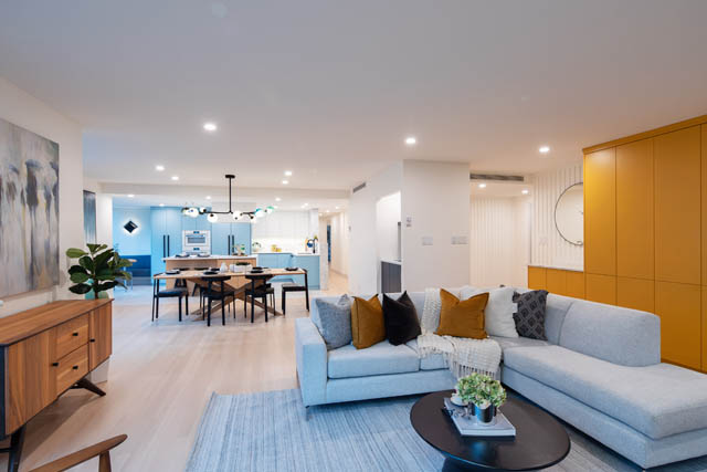 Spacious living room with modern furniture, hardwood floors, and a large window offering city views. - 1402 - 738 Broughton St, Vancouver Downtown