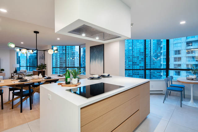Bright kitchen with modern white cabinetry, hardwood floors, and a stunning city view. - 1402 - 738 Broughton St, Vancouver Downtown