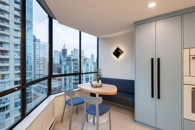Bright dining area with city view and modern light fixture. - 1402 - 738 Broughton St, Vancouver Downtown