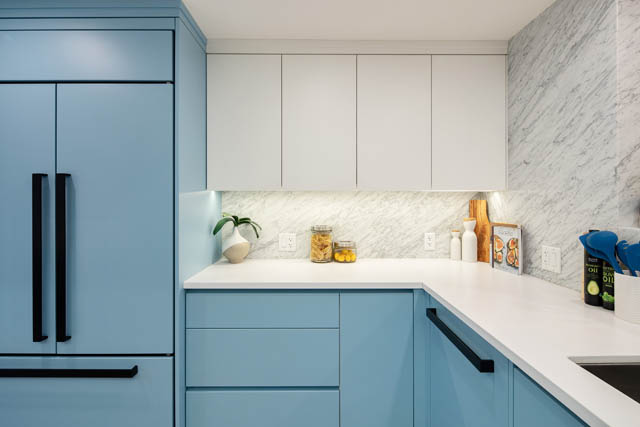 Bright kitchen with light blue cabinets, white marble countertops, and modern decor. - 1402 - 738 Broughton St, Vancouver Downtown