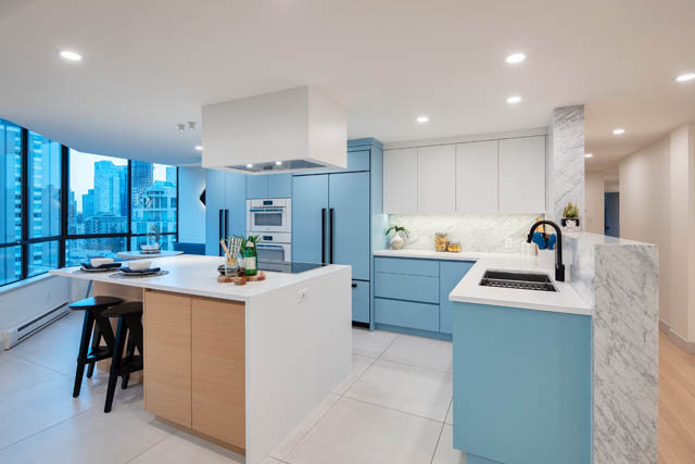 Bright kitchen with blue cabinetry, white countertops, and city view. - 1402 - 738 Broughton St, Vancouver Downtown