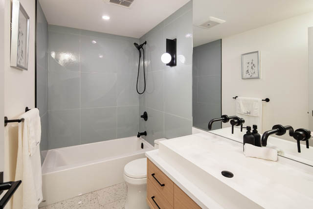 Bright bathroom with white countertops and black fixtures, modern design. - 1402 - 738 Broughton St, Vancouver Downtown