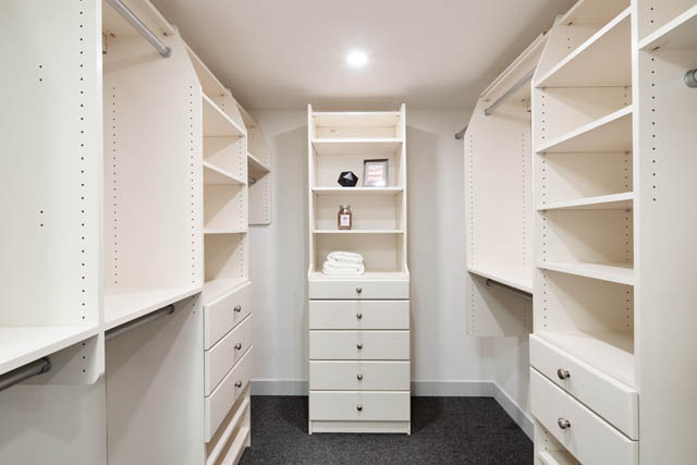 Bright walk-in closet with ample shelving and drawers, perfect for organization. - 1402 - 738 Broughton St, Vancouver Downtown