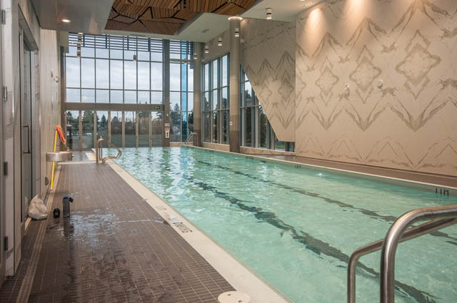 Spacious indoor pool with large windows and modern decor. - 907 - 680 Seylynn Crescent, North Vancouver