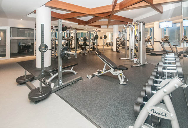 Spacious gym with various exercise equipment and mirrors. - 907 - 680 Seylynn Crescent, North Vancouver