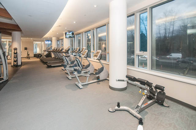 Spacious gym with cardio machines and large windows. - 907 - 680 Seylynn Crescent, North Vancouver