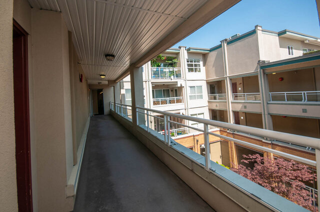 Spacious balcony with modern railings and a view of the building below. - 313 - 108 West Esplanade Ave, North Vancouver