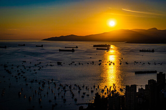 Sunset over the water, city view from a 3-bedroom, furnished Vancouver Downtown condo. - WITHHELD, Vancouver Downtown