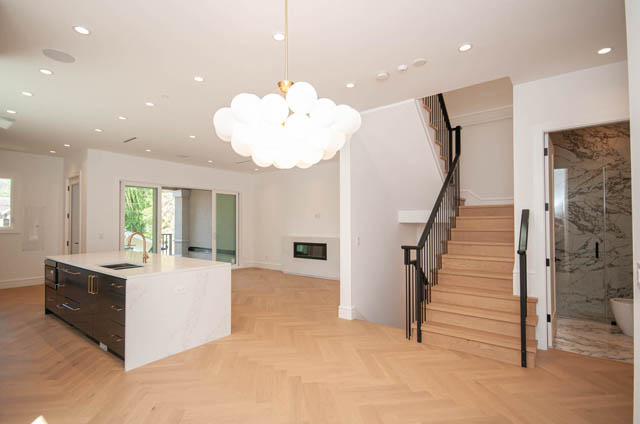 Spacious open-concept living area with white quartz countertops and herringbone hardwood floors. - 5909 Athlone Street, Vancouver West Side