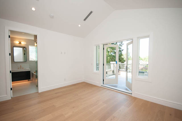 Spacious bedroom with light wood flooring and sliding glass doors to patio. - 5909 Athlone Street, Vancouver West Side