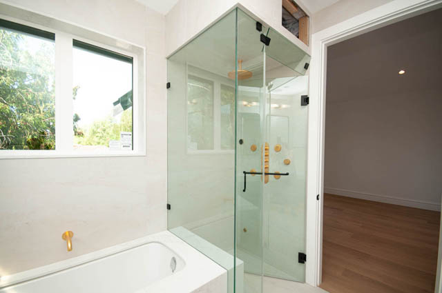Bright bathroom with glass shower enclosure and hardwood flooring. - 5909 Athlone Street, Vancouver West Side