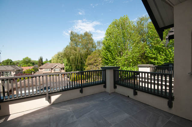 Balcony with stone flooring and tree-lined neighborhood view. - 5909 Athlone Street, Vancouver West Side