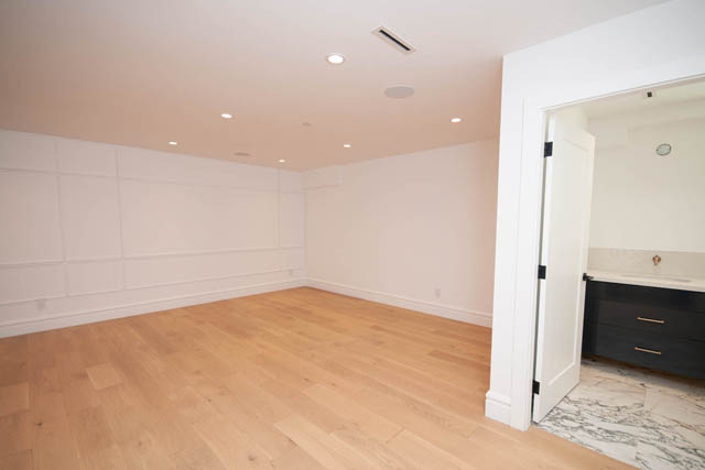 Spacious bedroom with light wood flooring and recessed ceiling lights. - 5909 Athlone Street, Vancouver West Side