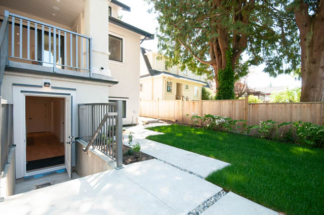 Outdoor patio with concrete walkway and lush green lawn in Vancouver West Side duplex. - 5909 Athlone Street, Vancouver West Side