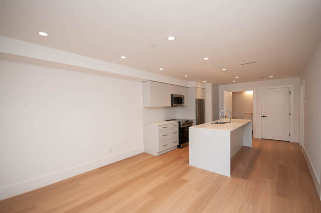 Bright kitchen with white quartz countertops and light wood hardwood floors. - 5909 Athlone Street, Vancouver West Side
