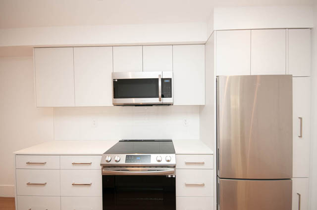 Bright kitchen with white cabinetry and stainless steel appliances. - 5909 Athlone Street, Vancouver West Side