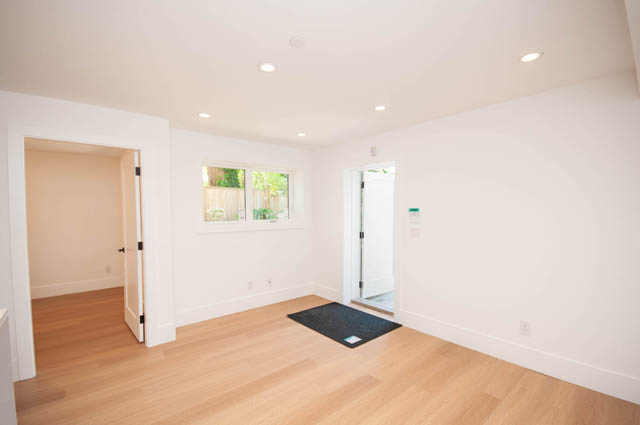 Spacious living room with hardwood floors and natural light through the garden-view window. - 5909 Athlone Street, Vancouver West Side