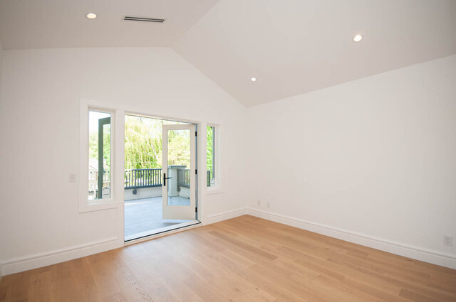 Spacious living room with hardwood floors and large windows leading to a balcony. - Upper - 5909 Athlone St, Vancouver West Side